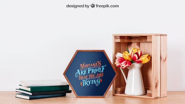 PSD mockup of frame on desk with books and plant