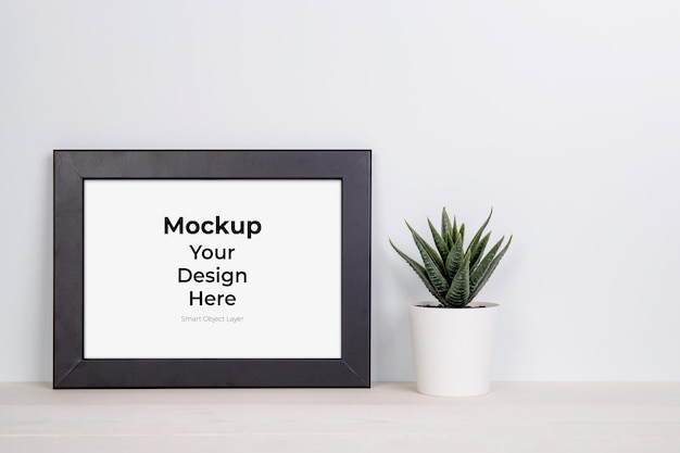 PSD mockup frame en planten in pot op tafel