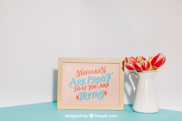 mockup of frame next to red flowers