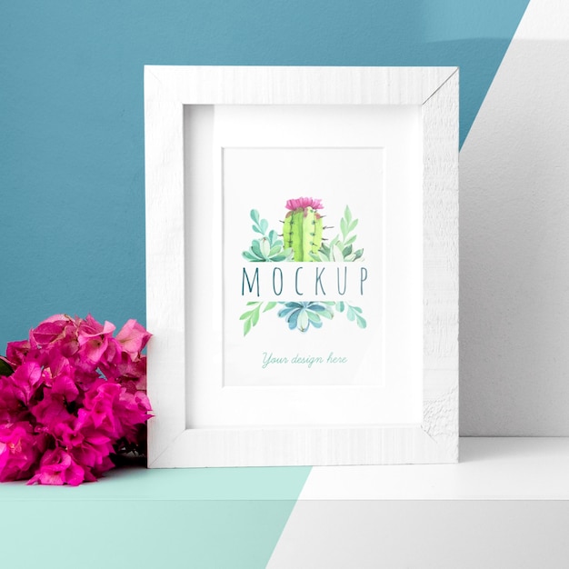 Mockup frame on table next to flowers