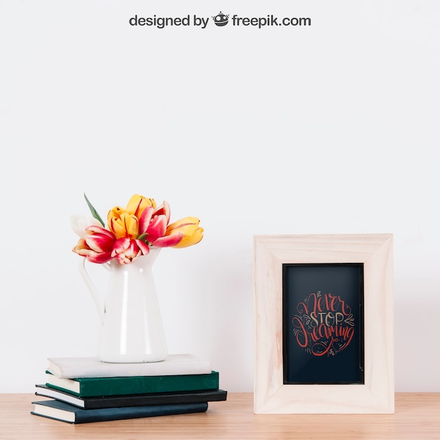 mockup of frame next to three books