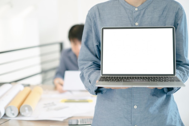 PSD mockup image of engineers showing laptop design building project in office