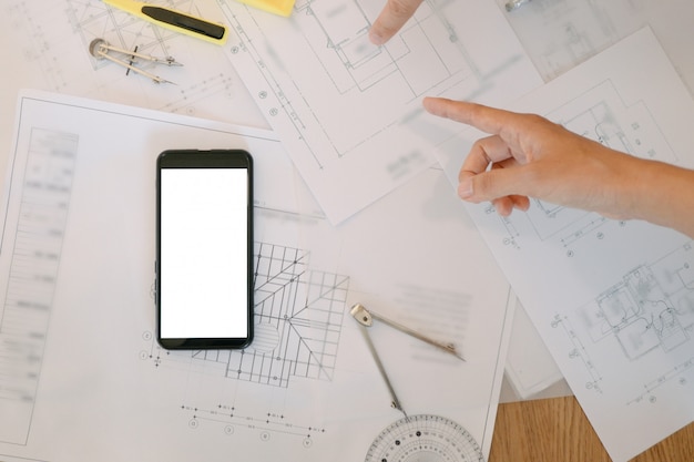 PSD mockup image of engineers tools with blueprint and calculator on wood table in the office