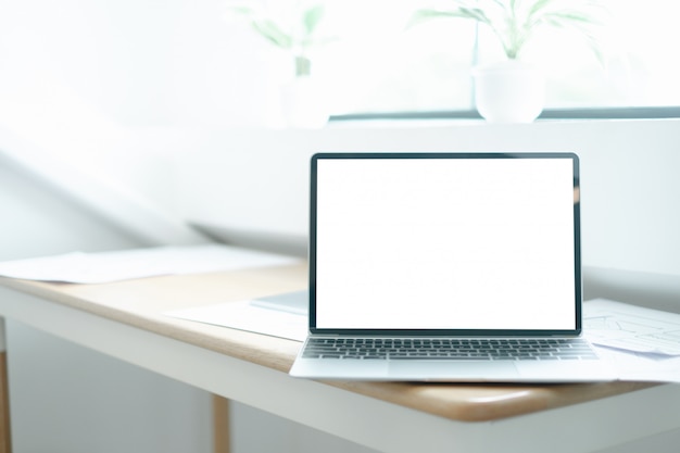 PSD mockup image of laptop on wood table with equipment of the mobile application graphic designer