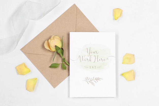 Mockup invitation card with envelope, rose and petals