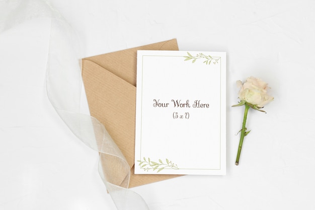 Mockup invitation card with envelope, rose and ribbon