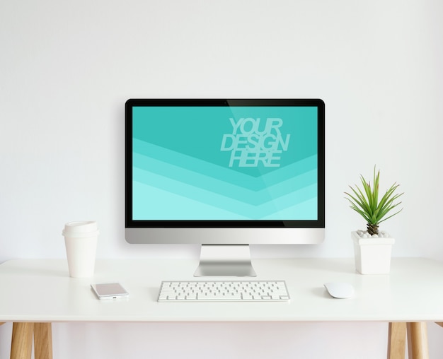 Mockup of laptop on desk with coffee cup and plant