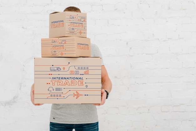 PSD mockup of man with cardboard boxes