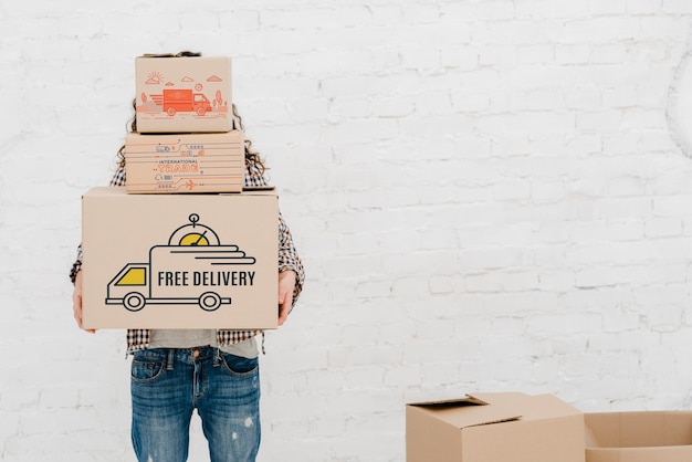 PSD mockup of man with cardboard boxes