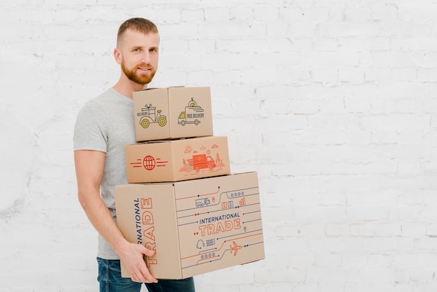 PSD mockup of man with cardboard boxes