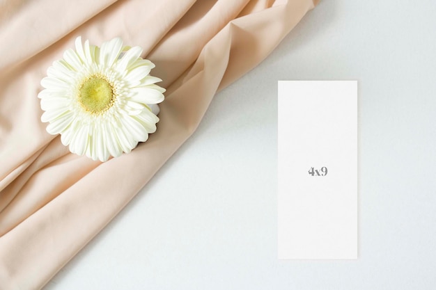 PSD mockup menu card with gerbera leaves and nude fabric