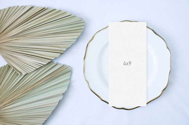 PSD mockup menu card with leaf palm on the plate and white background