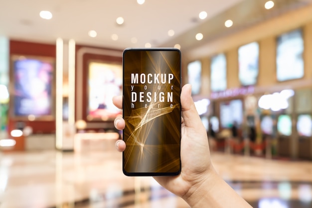 Mockup mobile phone  with blurred image hall of ticket sales counter