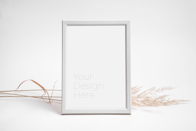 Mockup of photo frame decorated with dried grass