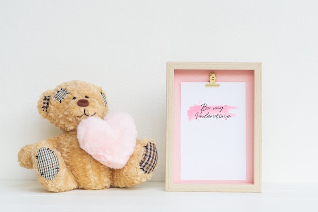 PSD mockup picture frame and cute bear with pink heart.