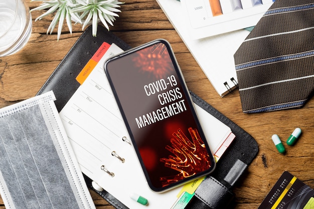 Mockup smartphone for Covid-19 Crisis Management background concept.