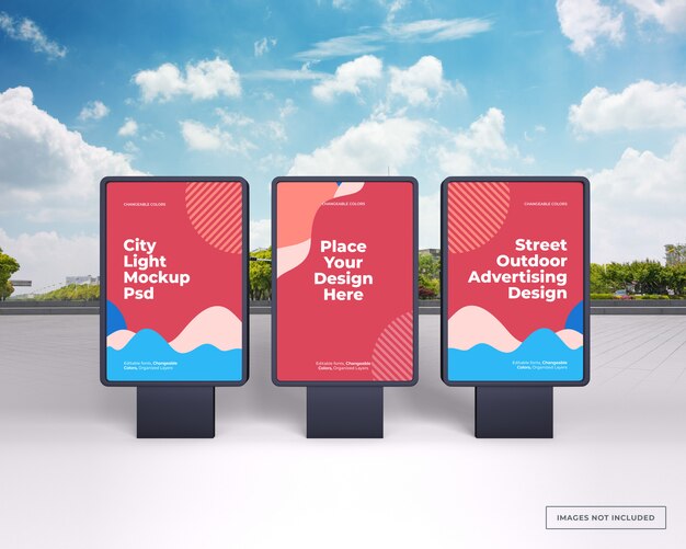 Mockup of three black vertical outdoor advertising stands on city street