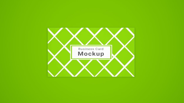 Mockup van een visitekaartje met geometrisch patroon op groen oppervlak