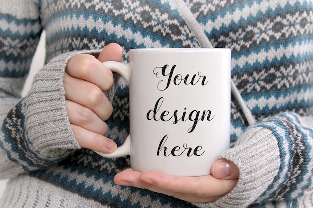 Mockup of a white coffee mug in woman's hands