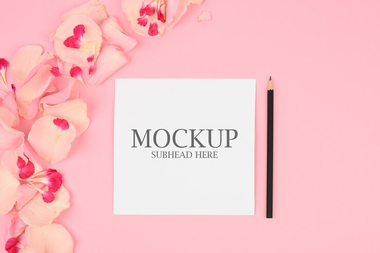 Mockup of white paper and pink flowers on a pink background