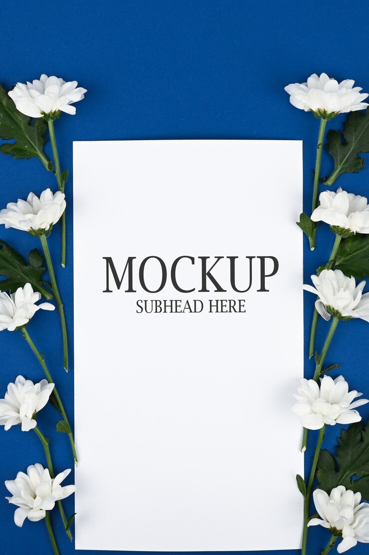 Mockup of white paper and white flowers on a blue background