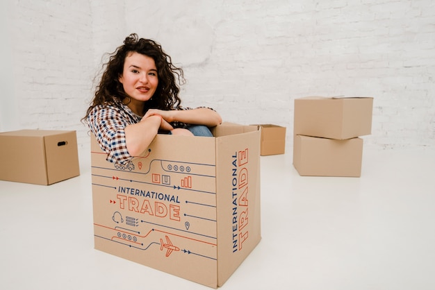 PSD mockup of woman with cardboard boxes