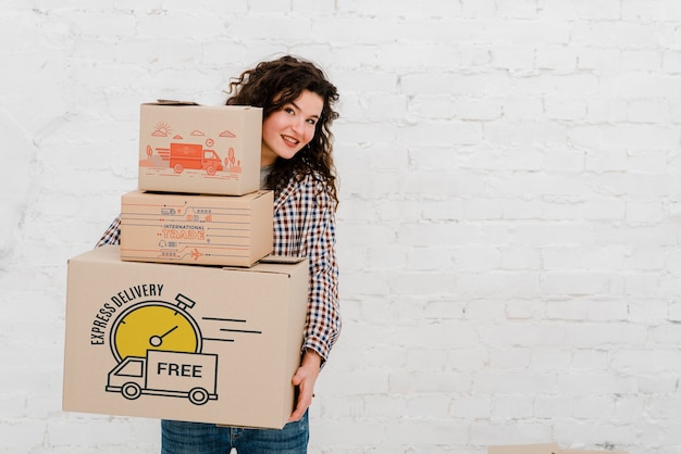 PSD mockup of woman with cardboard boxes