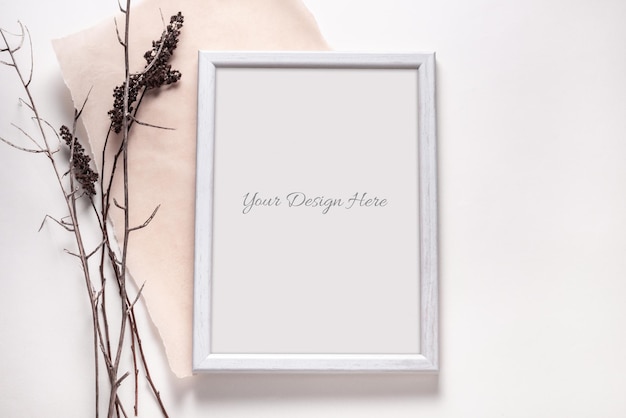 PSD mockup of wooden photo frame with grass branches