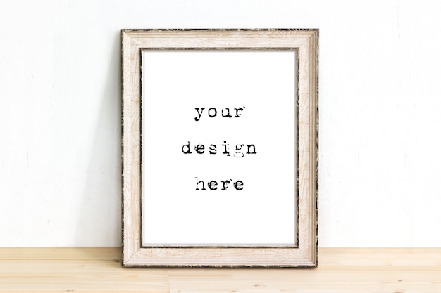 mockup of a wooden rustic picture frame standing on table