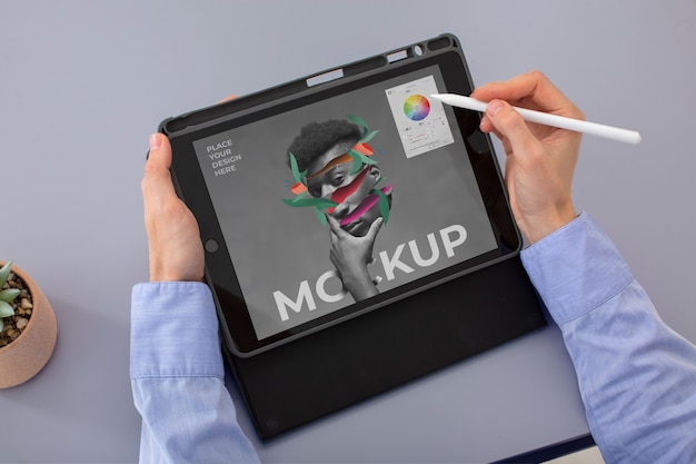 Model holding pencil and tablet mockup high angle
