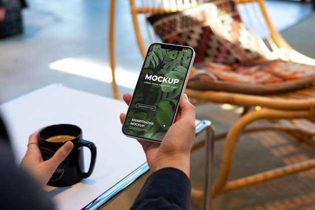 PSD model holding a smartphone mockup