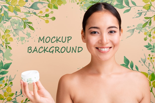 model looking at camera while holding a skin lotion