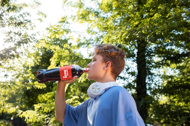 PSD model posing with bottle mockup