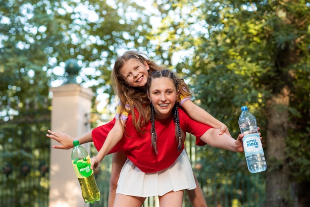 Models posing with bottle mockup