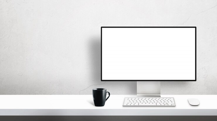 PSD modern profesional designer computer monitor mockup on office desk with copy space beside on wall