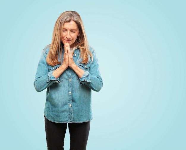 Mooie senior vrouw bidden op een heilige manier, bedelen