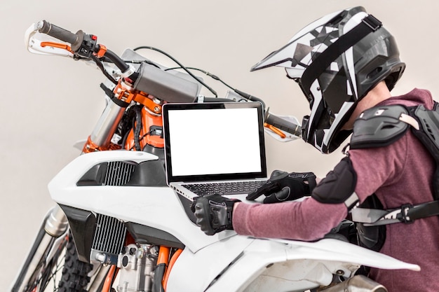 Motorcyclist holding laptop