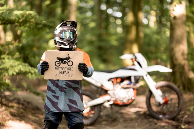 Motorcyclist holding sign