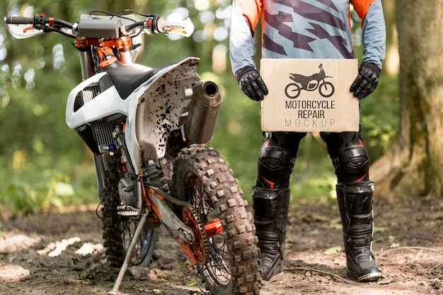 Motorcyclist holding sign