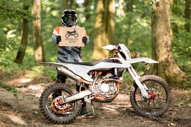 Motorcyclist holding sign