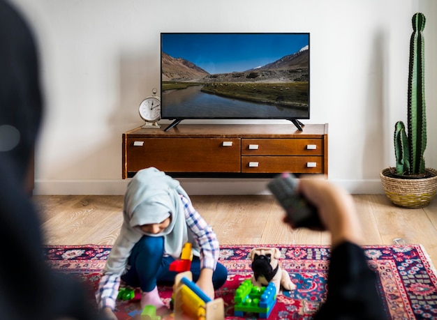 Muslim family relaxing and playing at home