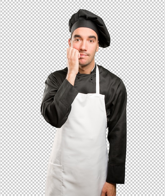 Nervous young chef posing