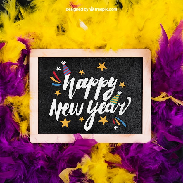 PSD new year mockup with slate and purple and yellow feather