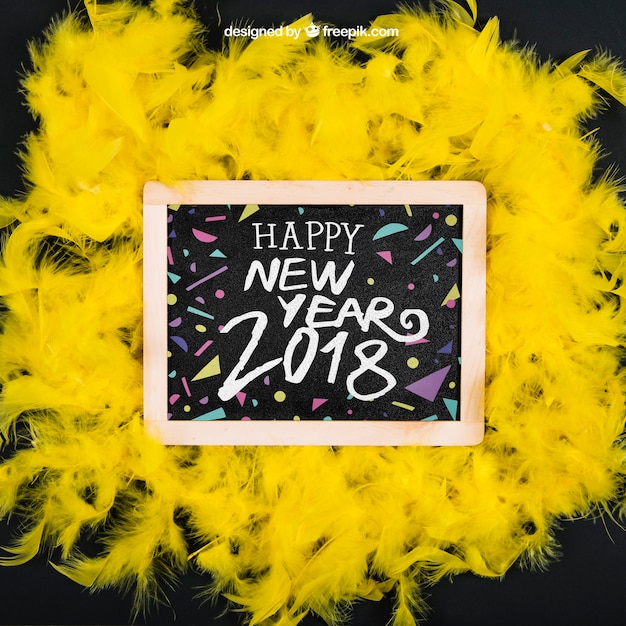 New year mockup on yellow feathers with slate