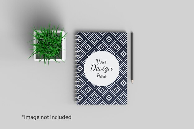 PSD notebook mockup bovenaanzicht met plant