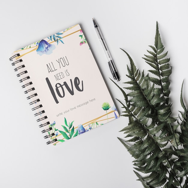 Notebook mockup next to leaves