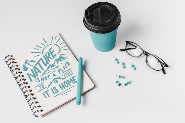 Notebook mockup with take away coffee cup