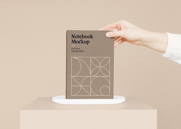 Notebook with hand mockup