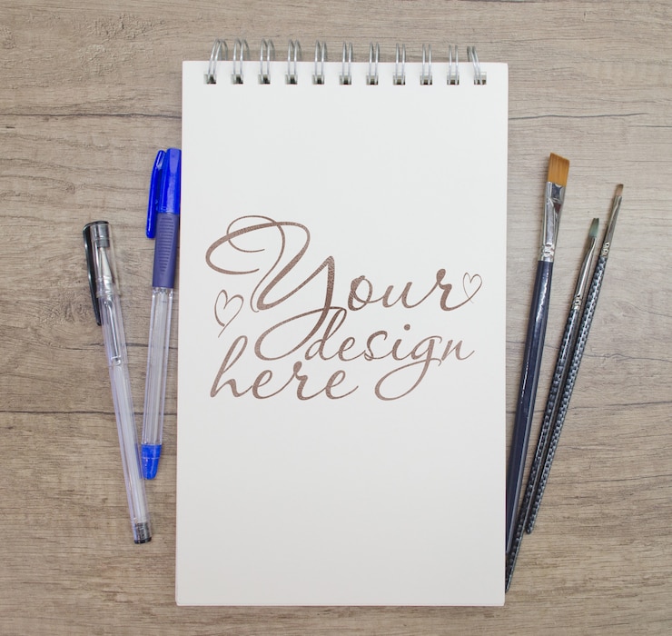 PSD notepad mockup with brushes and pen