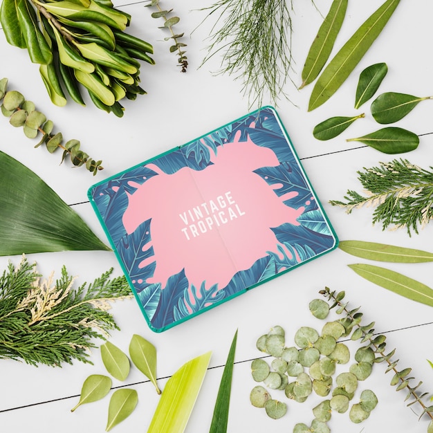 notepad mockup with tropical leaves